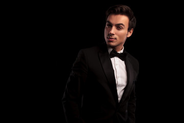 Obraz premium cool young man in tuxedo and bowtie posing