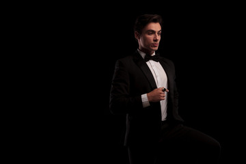 elegant man in tuxedo wearing a big gold ring