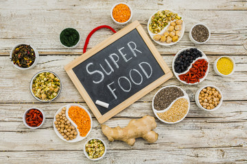 Superfood and healthy food on wooden background. 
