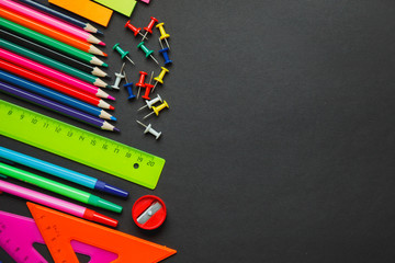 School supplies border on a chalkboard background