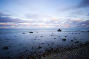 Obraz premium stony coast at sunrise, long time exposure, Baltic Sea Coast, Ruegen Island, Germany, Europe