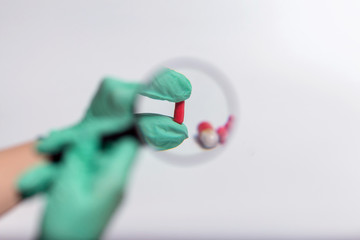 Pills through magnifying glass. Capsule and tablet 