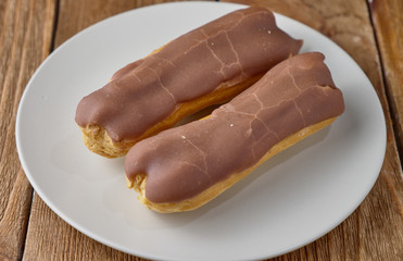 Homemade eclairs with cream and chocolate topping.