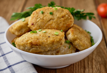 Chicken cutlets with vegetables on a wooden background