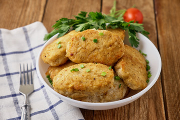 Chicken cutlets with vegetables on a wooden background