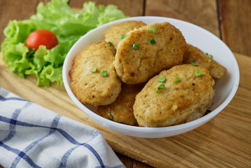Chicken cutlets with vegetables on a wooden background