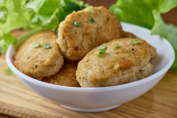 Fototapeta premium Chicken cutlets with vegetables on a wooden background