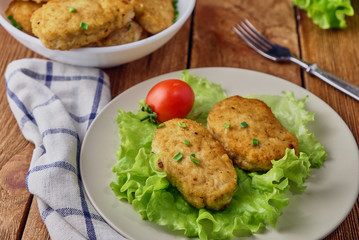 Chicken cutlets with vegetables on a wooden background