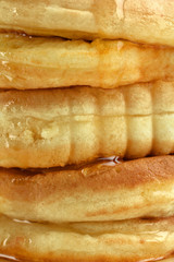 Close-up of a stack of pancakes with honey.