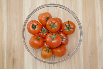 Fresh tomatoes in glass bowl
