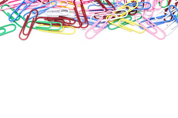 multi-colored paper clips on white background