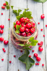 Glass jar full of fruits cherries and currants