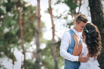 Beautiful wedding couple outdoors on blurred background, close up view