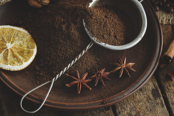 Roasted coffee beans and ground coffee in the plate