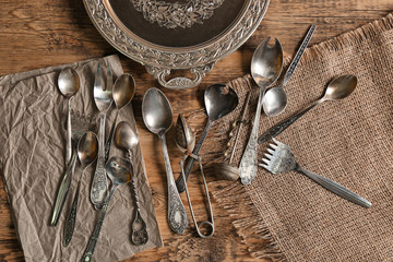 Set of silverware on wooden background