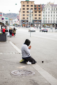 Beggar refugee begging for money on the street of European city