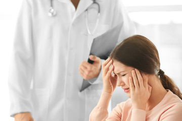 Young depressed woman at doctor's office