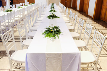 Chairs and tables in white for wedding party.