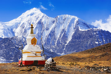 Buddhist stupa at Annapurna Circuit Treck with white summit view, Himalaya, Nepal, Asia. For horizontal postcard or calendar.