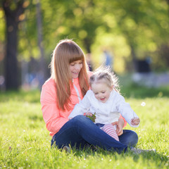 Mother and daughter in the park. Beauty nature scene