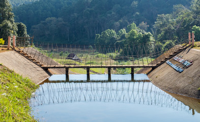 Fototapeta premium Wooden bridge over on reservoir