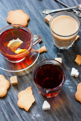 Black tea, milk tea, lemon tea in glass cups on a wooden table, selective focus