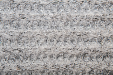 Gray melange fluffy woven thread sweater or scarf as a backgroun