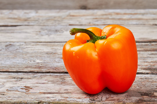 Orange Bell Pepper On Wood.