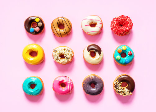 colorful donuts on pink background.
