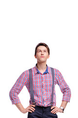 Thinking about solutions. Studio portrait of thoughtful young man looking up. Isolated on white.