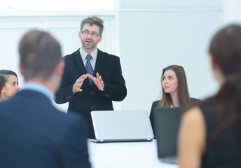 Finance Director holds a meeting with the employees of the compa © ASDF