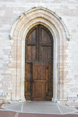 Fototapeta na wymiar The entrance wooden door in an old Italian house.