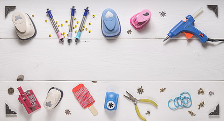 top view of wooden table with tools for scrapbooking and copy space