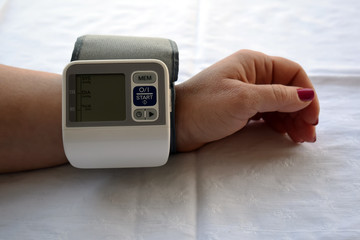 Woman is taking care for health with hearth beat monitor and blood pressure