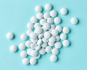 white pills on blue background
