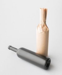 Two wine bottle are standing on gray background