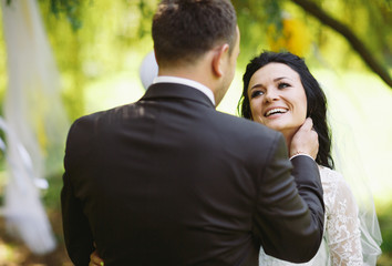 Charming smile of the bride next to the groom