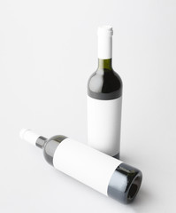 Two wine bottle are standing on gray background