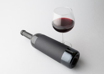 Wine bottle and wine glass on a gray background