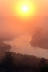 Misty sunrise over a small river
