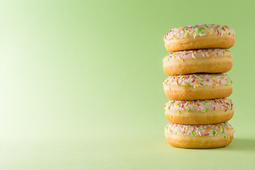 Stack of donuts on a green background
