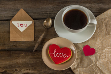 Valentine red cookie with heart shape and cup of coffee