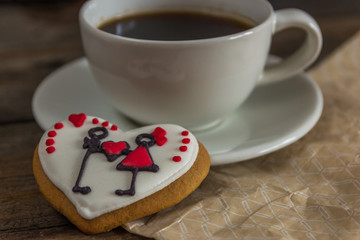 Valentine red cookie with heart shape and cup of coffee
