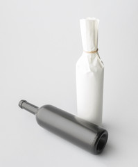 Two wine bottle are standing on gray background