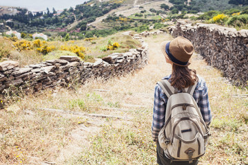 Hiker traveler woman on a hiking trail, travel and active lifestyle concept