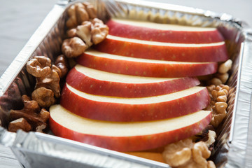 Healthy food in foil box, diet concept. Apple dessert