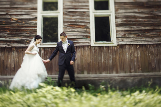 Blurred Picture Of Wedding Couple Walking Around Old Beautiful House