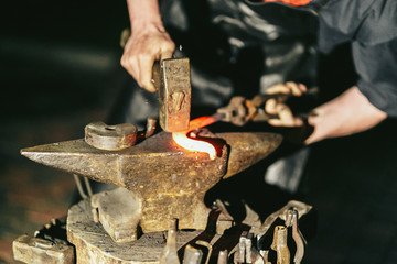 Blacksmith works with hot red steel