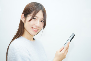 Young woman using a smart phone with smile