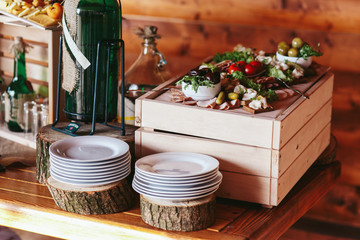 Pickled vegetables and empty plates lie on the wooden table